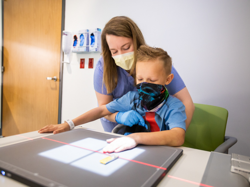 Patient Cooper Burk of Flora gets an X-ray from radiologic technologist Kelsey Wiggers at the new pediatric imaging center in the Kathy and Joe Sanderson Tower at Children's of Mississippi.