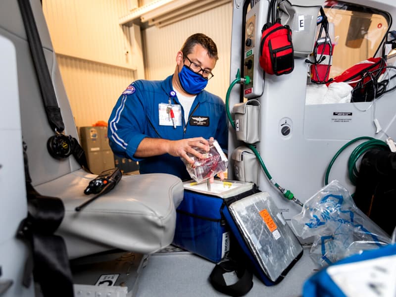 Flight paramedic Brad Harper stocks blood and blood products on board AirCare 1 as it waits at the Mississippi Center for Emergency Services to be dispatched on its next call.