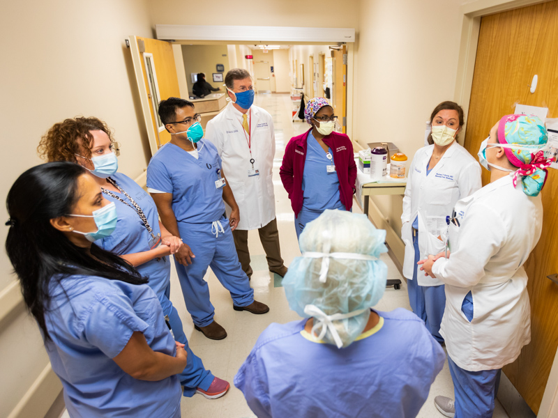Dr. Rachael Morris, second from right, associate professor of obstetrics and gynecology and a maternal-fetal medicine specialist, leads rounds on Wiser Hospital's labor and delivery floor in this July 2020 photo. The group includes Dr J. Martin Tucker, center in white coat, the department's chair.