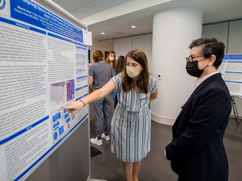 Rising M2 Aren Worrell Presnall discusses her research with Dr. Norma Ojeda, vice chair of pediatric research.
