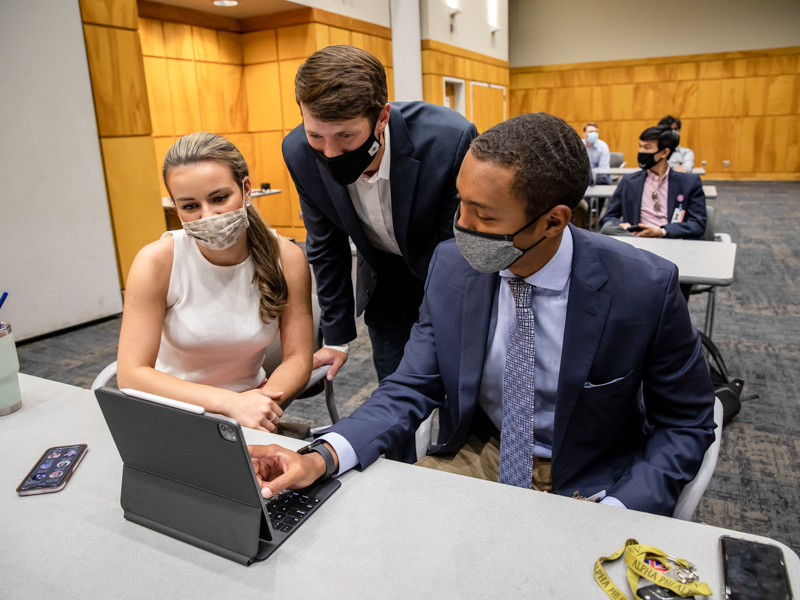 Incoming first-year dental students Tammy Vujanovic, Denton Garvey and Derrick Burt, all UPSTART participants, prepare for their presentations before the program's symposium.