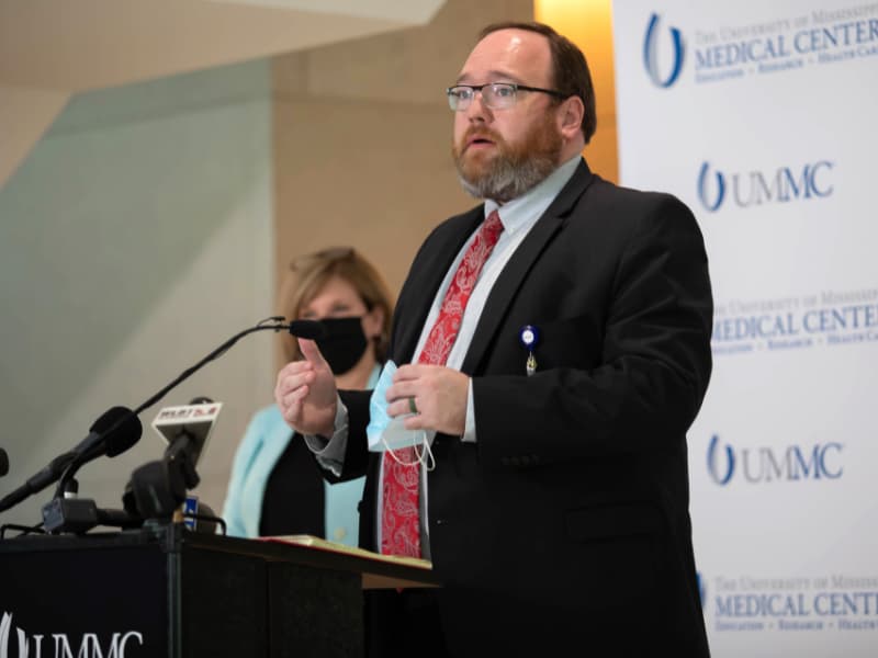 Dr. Jonathan Wilson, University of Mississippi Medical Center chief administrative officer, gives a report on ICU bed availability to media during a news conference Wednesday at the School of Medicine.