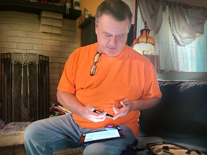 Ripley resident Dana Rhodes measures his blood sugar level, which will be automatically transmitted to the UMMC Center for Telehealth via Rhodes' cellular-enabled tablet.