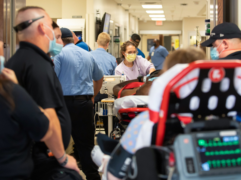 UMMC Emergency Department technician Abby Oliver takes the temperature of patients waiting to be treated and admitted.