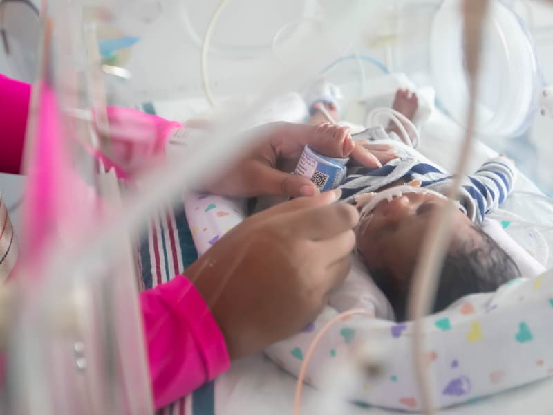 Portia Hayes spends time with her son, Jediah Johnson, in the Children's of Mississippi NICU.
