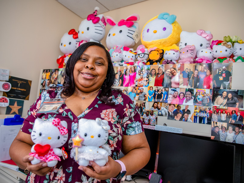 Surrounded by her Hello Kitty collection and pictures of coworkers, Shukundala 