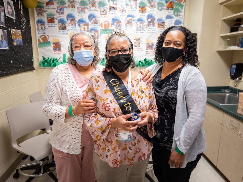 Helping Verlyne Broadway, center, celebrate her 50th work anniversary are her sister Bettie Wilson, lef, and daughter Keisha Kimbrough.