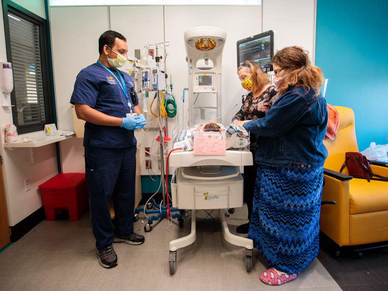 Dr. Renjith Kalikkot tends to his newborn patient, Adella Grace Cohen, to the relief of her grandmother, Donna Cohen, left, and her mother, Sara Cohen of Carriere.