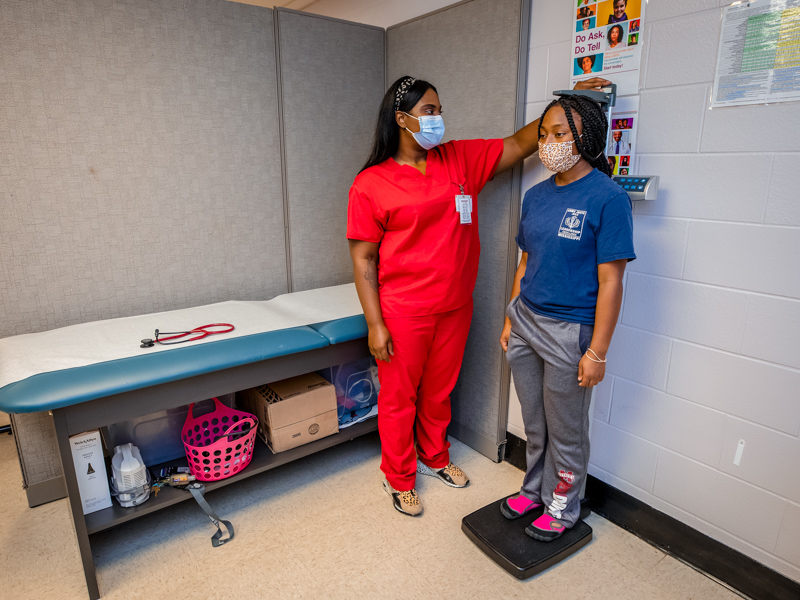 Medical assistant Jessica Morgan measures the height of Jamaya Barton at the Lanier clinic.