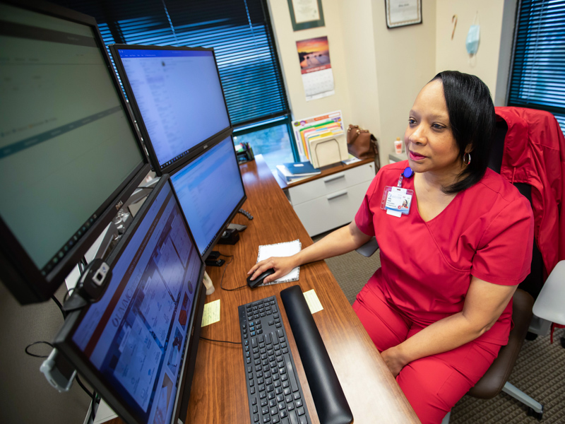 Registered nurse care coordinator Shirley Stasher reviews blood pressure data collected remotely using Bluetooth technology from a Center for Telehealth patient.