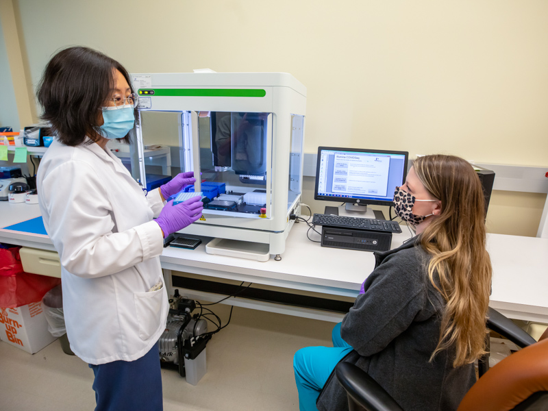 Researcher Wenjie Wu, left, and Scientist Ashley Johnson, right, work in the Molecular and Genomics Core Facility and are part of the team sequencing COVID-19 variants present in Mississippi, which now include Omicron.