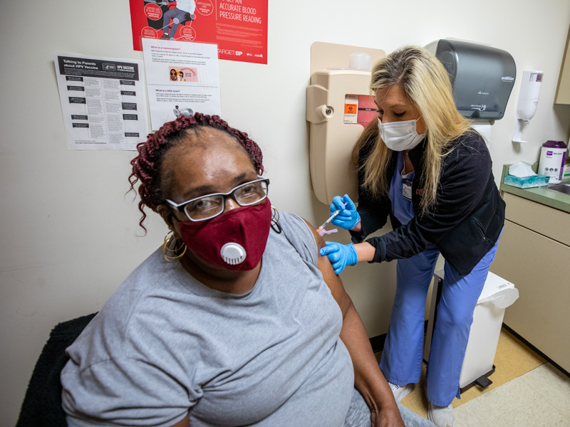 Kate Morgan, a registered nurse at the Flowood Family Medicine Clinic, gives patient Sheila Myers of Jackson her COVID-19 booster shot.
