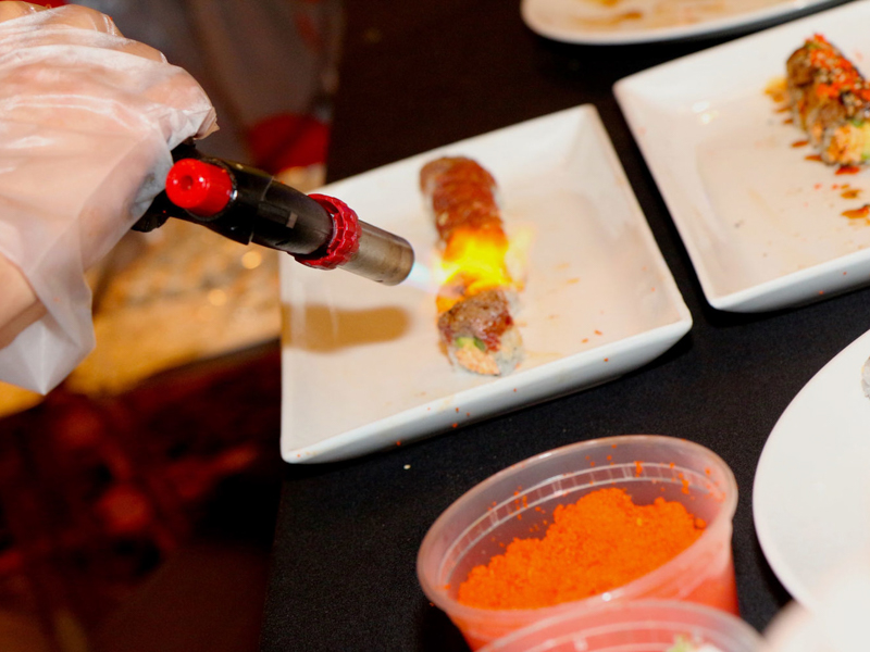 A chef toasts sushi rolls before pairing with wine at the 2017 Sante South festival. (Photo Credit: Tony Perkins)