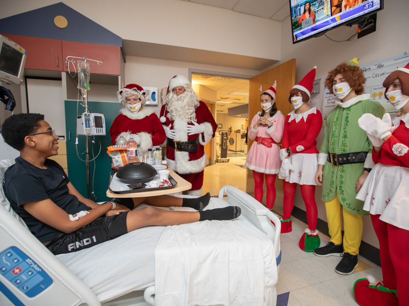 Children’s of Mississippi patient Cameron Allen gets a visit from Santa and Mrs. Claus and the elf crew during an inpatient visit at Blair E.Batson Tower Wednesday. Members of the Claus family are, from left, Dr. Mary Taylor, Michael Taylor, Katie Taylor, Cillie Taylor, Jackson Taylor and Aubrey Taylor.