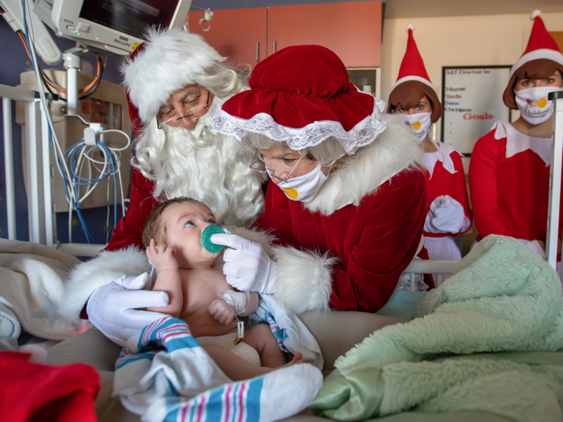 Children’s of Mississippi patient two-month-old Henry Carpenter gets a visit from Santa and Mrs. Claus and their elves during an inpatient visit at Blair E.Batson Tower Wednesday.