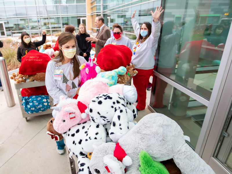 Children's of Mississippi Child Life specialists Cara Williams, front, and from left, Kelsey Clark, Ashley Prendez and Pepper Weed-Cooper wheel carts full of stuffed animals donated by Nicholas Air, a private aviation company, into Children's of Mississippi.