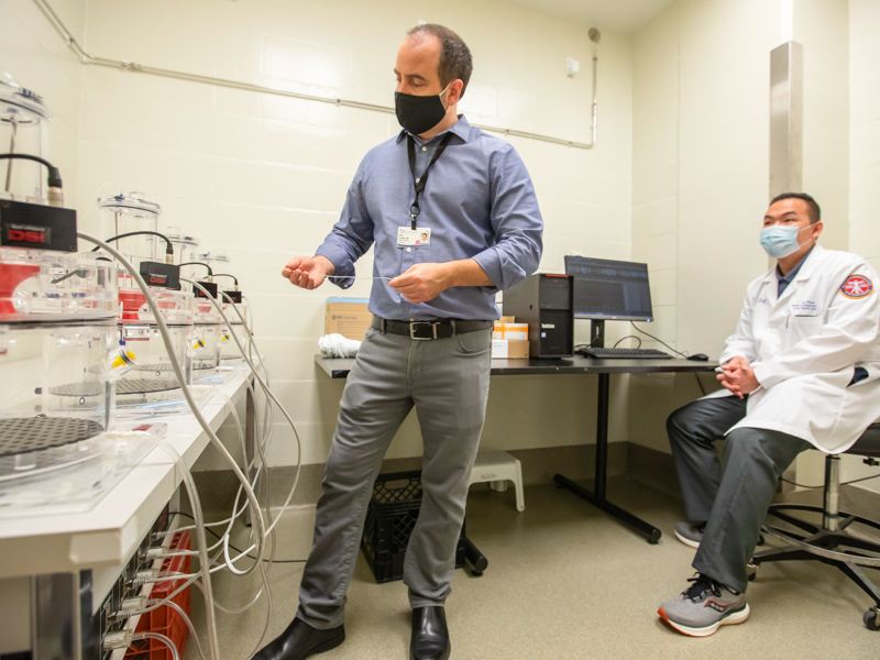 Dr. Kevin Freeman, left, and School of Graduate Studies in the Health Sciences PhD student Loc Pham perform opioid use research in the Translational Research Center.