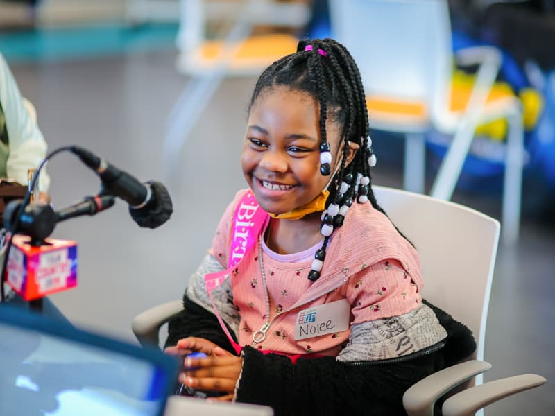 Wearing a birthday sash, Nolee Kelis Jones of Pearl smiles during the first day of the 2021 Mississippi Miracles Radiothon.