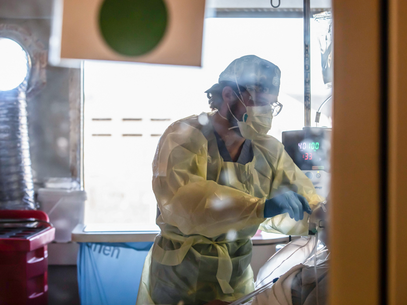 Registered nurse Samm Thompson cares for a COVID-19 patient in the Medical Intensive Care Unit.