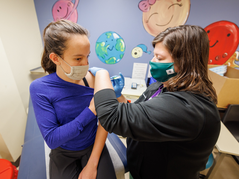 Kehle Hutto of Madison gets her second dose of the Pfizer-BioNTech COVID-19 vaccine from Kristen Cherry, nurse manager at Children's of Mississippi's Batson Kids Clinic.