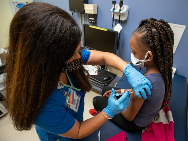 Nurse manager Gretchen Holloway gives Jayla Smith of Jackson a vaccination protecting her from COVID-19 in Nov. 2021.