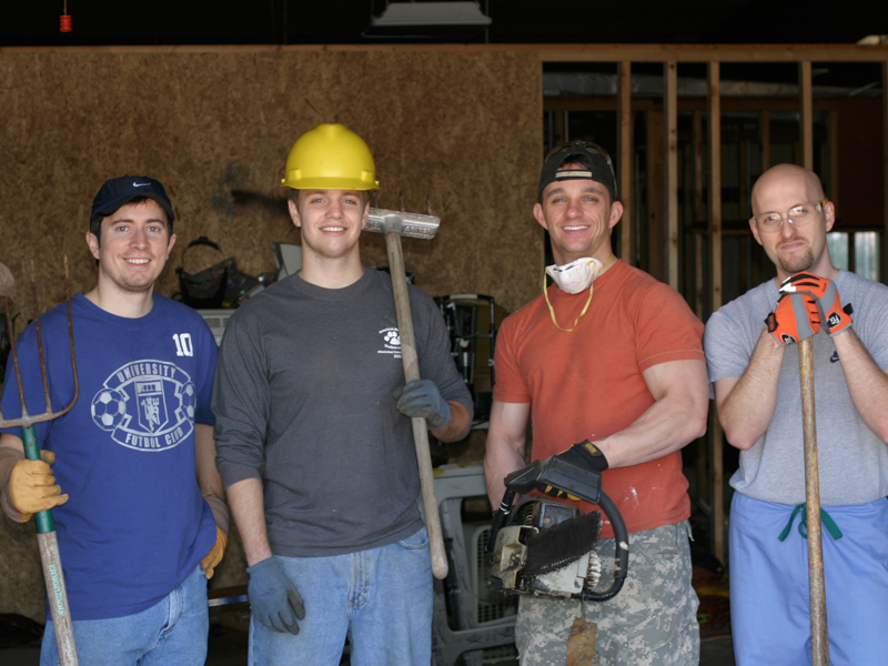 Dr. Bobby Tullos, second from right, shown here a decade ago, pitched in to help remodel the clinic with his fellow student volunteers. From left are the 2012 versions of Dr. Bradley Deere, now assistant professor of medicine, cardiology, at UMMC; Dr. Stephen Sills; (Tullos); and Dr. Jeb Clark.