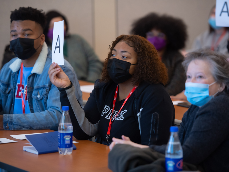 It's "Two Truths and a Lie" time during the presentation by the School of Graduate Studies in the Health Sciences. Students indicate by signs which statements about science are true and which is false. (Photo by Kevin Bain/The University of Mississippi Marketing Communications)
