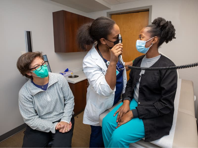 Dr. Melissa McNaull, left, observes as second-year family medicine resident Dr. Jessica 