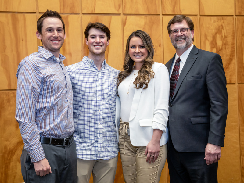 School of Dentistry Research Day award winners are, from left, first-year dental students Michael Bierdeman, Denton Garvey and Tamara Vujanovic, pictured with Dr. Jason Griggs.