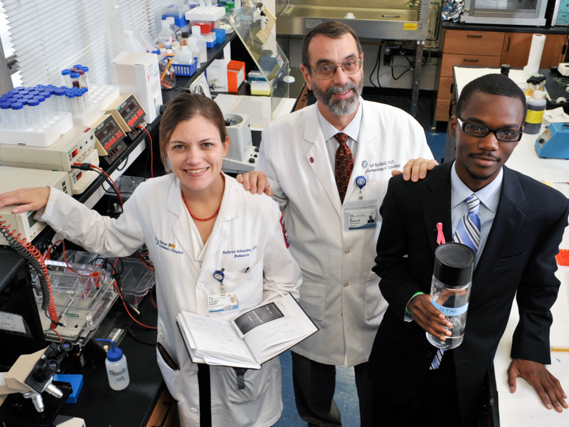 In a 2011 photo, Rockhold stands with Base Pair alums Dr. Kathryn Schneider and Justin Porter. Schneider is now an associate professor of pediatrics and assistant dean for medical school admissions at UMMC; Porter works in intellectual property and public policy.