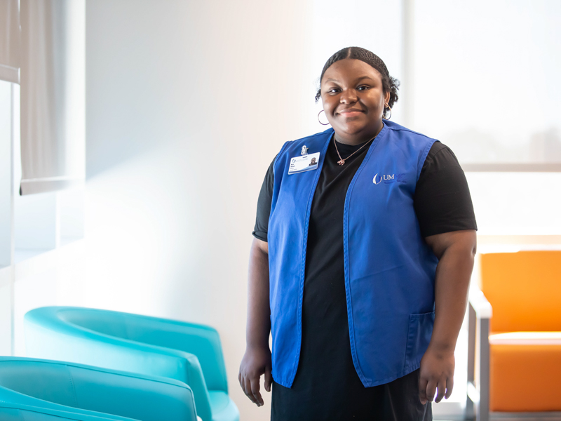 Mya Woods, a graduate student in biomedical sciences, volunteers in the reception area of the Pediatric Intensive Care Unit at the Sanderson Tower.