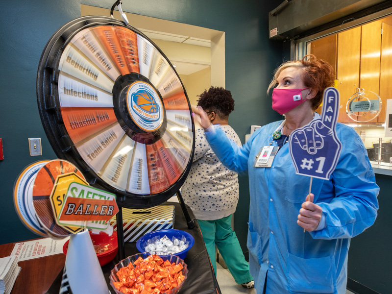 Medical technologist Angela Phillips gives the safety trivia wheel a spin.