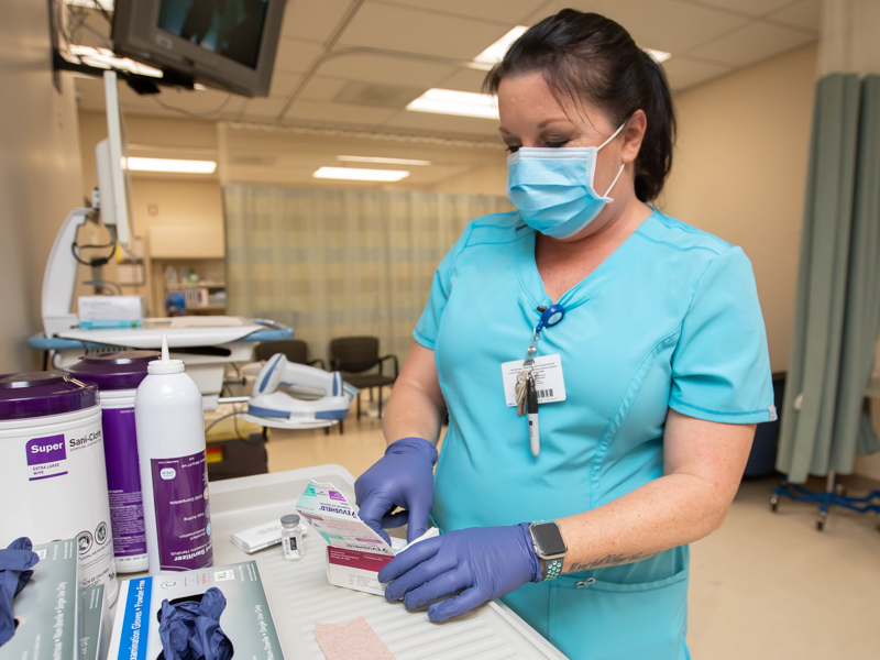 UMMC Cancer Center and Research Institute Oncology Registered Nurse Christy Perrigin unpacks two vials of Evusheld