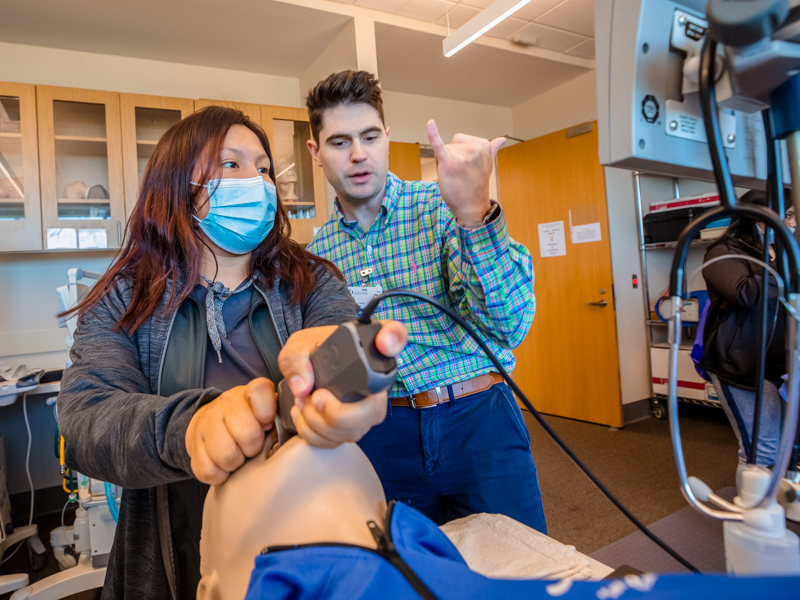 Terrca Hickman, a Choctaw Central High junior, intubates a medical manikin, guided by Andrew Shelby, educator in the Life Support Training Center, part of the Simulation and Interprofessional Education Center in the School of Medicine. Jay Ferchaud/ UMMC Communications