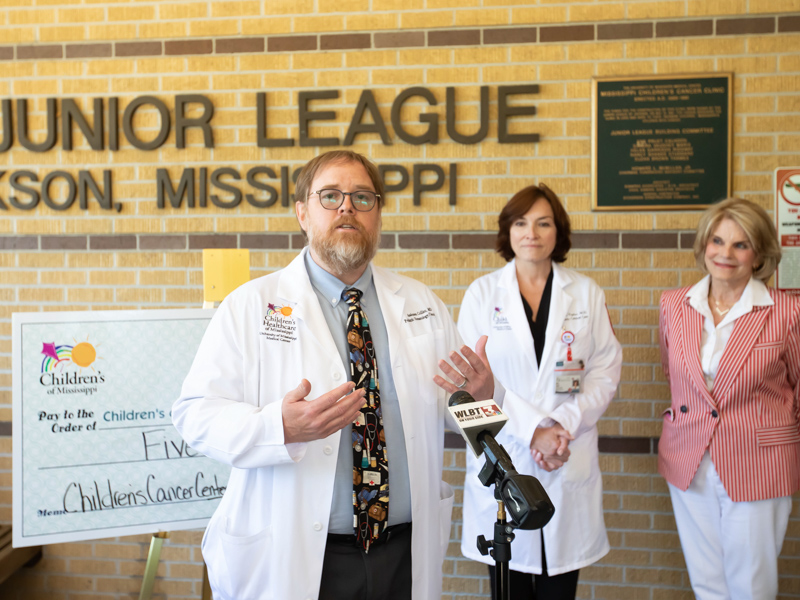 Dr. Anderson Collier, director of the center and chief of pediatric hematology-oncology, tells more about the coming renovation of the Center for Cancer and Blood Disorders. Looking on are, from left, Dr. Mary Taylor, Suzan B. Thames Chair and professor of pediatrics; and Suzan Thames, an early supporter of the center.