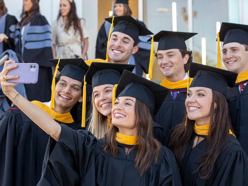 Ali Garriga, who earned a Master of Science degree in Biomedical Sciences, takes a selfie with her classmates.