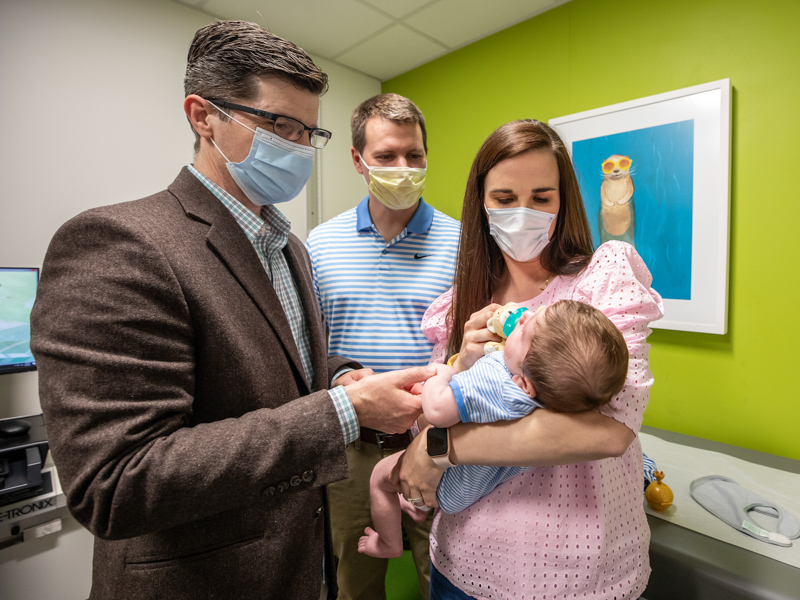 Rachel and Stephen Sims watch over son Bishop as Dr. Phillip Burch prepares to examine his tiny chest following heart surgery.