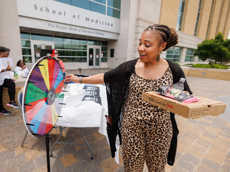 Dr. Kristin Nalls, School of Dentistry assistant dean for student affairs and inclusion, spins for a chance to win a prize outside the School of Medicine during Employee Appreciation Week. Joe Ellis/ UMMC Communications
