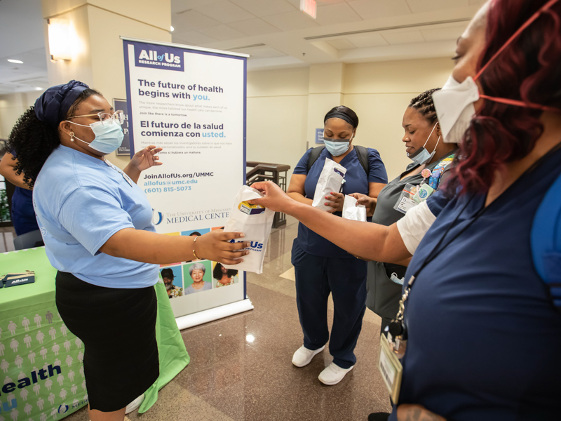 Biobank participant recruiter Hailey Spillers, left, talks with certified phlebotomists Myesha Scott, center, Ashford Smith and Tiffany Thomas about the All of US research program during Employee Appreciation Week in May.