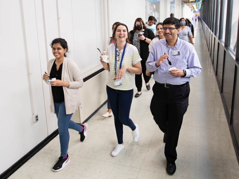 School of Dentistry graduate students Sheetal Chowdhury, far left, and Laura Alberto walk with Dr. Amol Janorkar, professor and chair of the SOD Department of Biomedical Materials Science, on an ice cream break as part of Employee Appreciation Week. Melanie Thortis/ UMMC Communications 