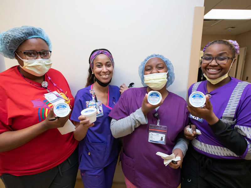 From left, pharmacy technicians Tiana Hathorn, Chiquita Campbell, Tierra Mozee and Terri Irving are all smiles after getting an ice cream happy from senior hospital leaders as part of Employee Appreciation Week. Melanie Thortis/ UMMC Communications