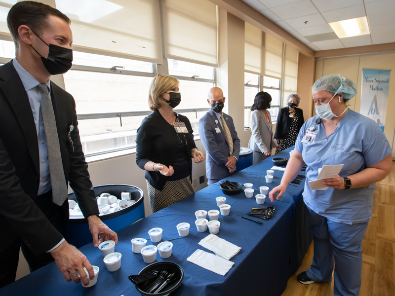 Radiologic technologist Ashley Alexander gets a cup of ice cream from senior hospital leaders Brian Rutledge, Dr. LouAnn Woodward and Dr. Alan Jones and others as part of Employee Appreciation Week. Melanie Thortis/ UMMC Communications