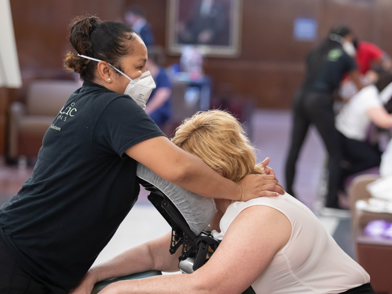 Massage therapist Nina Tieu with Therapeutic Connection massages School of Medicine education administrator Cindy Chesteen as part of Employee Appreciation Week. Melanie Thortis/ UMMC Communications