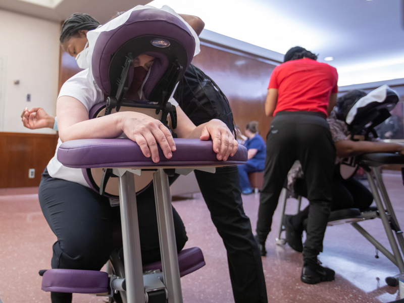 School of Medicine division business administrator Ellie Hales receives a massage from massage therapist Amy Dixon with Therapeutic Connection after making a donation to the Medical Center as part of Employee Appreciation Week. Melanie Thortis/ UMMC Communications