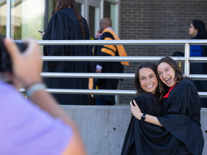 School of Dentistry dental hygiene graduates Allyson May, left, and Morgan Meek pose for a photograph prior to commencement ceremonies.