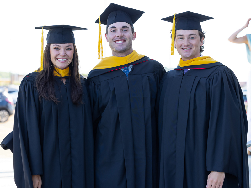 Master of Biomedical Science graduates, from left, Meredith Minshew, Reid Fracchia and Tyler Trussell are all smiles before commencement.