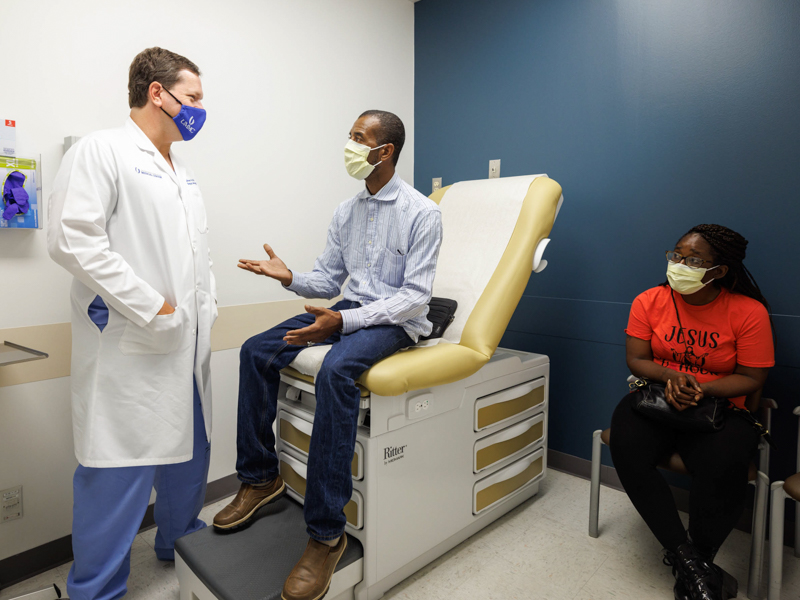 Darrell Freeman, center, details recovery from his HIPEC surgery following an exam by his surgeon, Dr. Shannon Orr. With Freeman is his fiancée, Tonya Johnson.