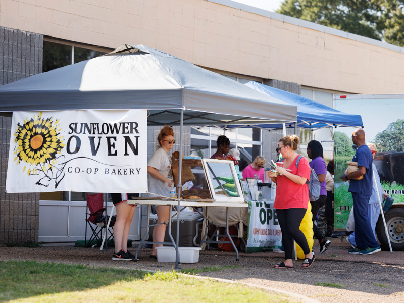 UMMC employees browse products from several local vendors at Thursday afternoon's Farmer's Market behind Backyard Burger. The event was sponsored by the UMMC Office of Well-being. Joe Ellis/ UMMC Communications