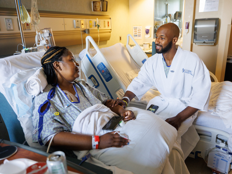 Quinten Hogan makes sure his mom, Tawanna Davis, is doing well following surgery June 28 in which Hogan gave his mom his left kidney. The next morning, both were doing well and preparing to return home later in the week. Joe Ellis/ UMMC Communications 