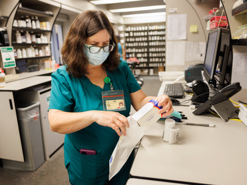 Pharmacist Grace Parmley bags COVID meds at the UMMC pharmacy located in the Pavilion.